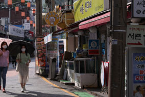 What Explains the COVID-19 East-West Divide?