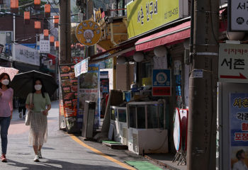 What Explains the COVID-19 East-West Divide?