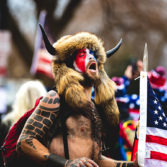 Conspiracy Pushers: QAnon’s Radical Unreality