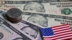 Dollar banknote and coin with US flag