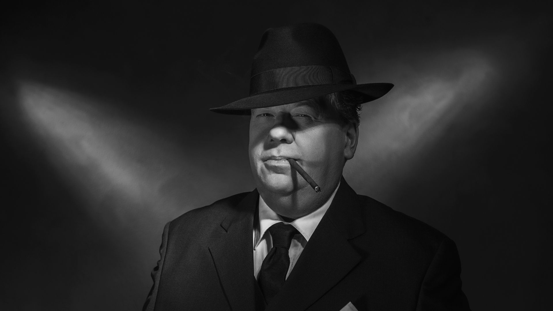 Retro 1930s gangster smoking cigar. Classic black and white portrait.